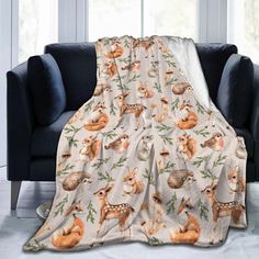 a blanket with deers on it sitting in front of a couch