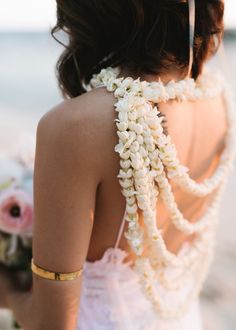 the back of a woman's dress with flowers on it