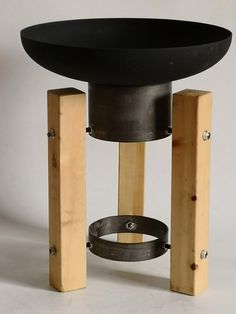 a wooden table with black top and metal base