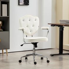 a white office chair sitting on top of a hard wood floor next to a book shelf