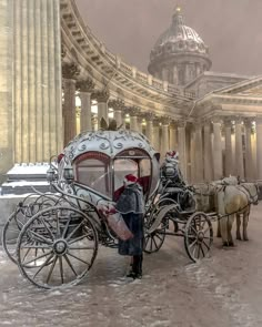 a man standing next to a horse drawn carriage in front of a building with columns