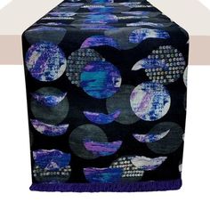 a blue and purple table runner with circles on it