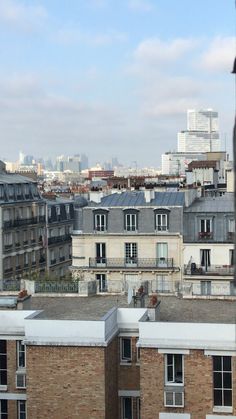 the city skyline is seen from an apartment building