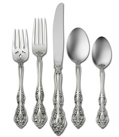 an assortment of silverware including forks, knives and spoons on a white background