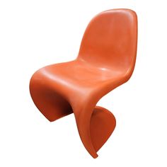 an orange plastic chair on a white background