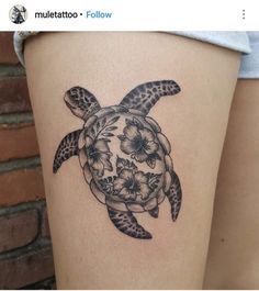 a woman's thigh with a turtle tattoo on it