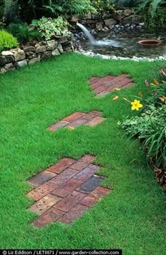 a garden with green grass and brick walkways