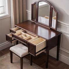 a dressing table with drawers and a mirror