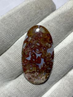 a brown and white stone sitting on top of a couch