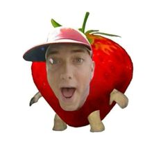 a man in a baseball cap with a strawberry on his head and tongue sticking out