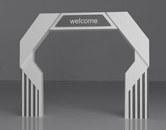 a white welcome arch with the word welcome written on it in front of a gray background