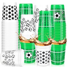 a group of green cups with soccer balls on them