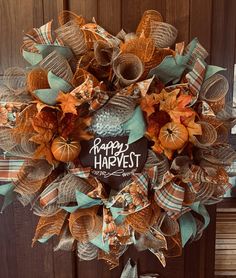 a happy harvest wreath hanging on a door