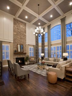 a living room filled with furniture and a fire place in the middle of a room