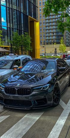 a black car is parked on the street