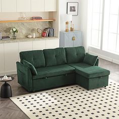 a living room with a green couch and white rug