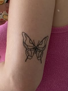 a woman's arm with a tattoo of a butterfly on the left side of her arm