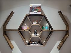 the shelves are made out of wood and have various items on them in hexagonal shapes