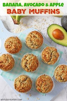 banana, avocado and apple baby muffins on a blue towel next to an avocado