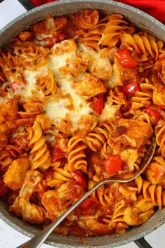 a skillet filled with pasta covered in sauce and cheese