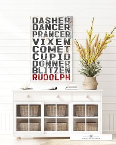 a white cabinet with baskets on top and a sign above it that says dasher dancer