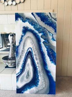 a blue and white painting sitting on top of a counter