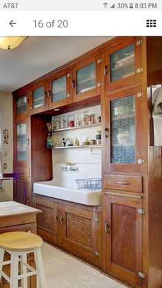 a kitchen with wooden cabinets and white counter tops