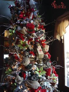 a christmas tree decorated with burlocks and bows