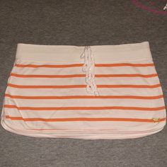 White Vintage Mini Skirt With Orange Stripes. Signature Dog Logo Embroidered On Lower Front Corner In Gold. Patch On Back That Reads “Royal Pink Beach Club Love Pink” Cute Rope Tie Drawstring Closure. Size Small, Brand New With Tags. Measurements Laying Flat Are About: Waist: 15.5” Length: 10” Bottom: 17.5” Check Out My Closet For More Pink! Vintage Mini Skirt, Style Mini Skirt, Royal Pink, Rope Tie, Dog Logo, Pink Beach, Pink Vintage, Orange White, Beach Club