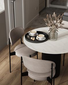 a white table with two chairs around it