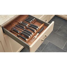 an open drawer with knives in it