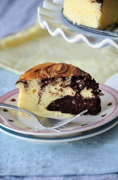 a piece of cake on a plate with a fork in front of it and another slice missing