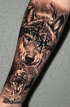 a man's arm with a wolf and compass tattoo on it