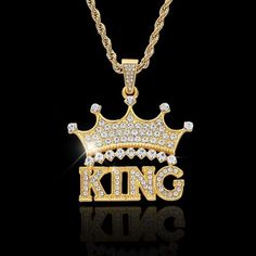 a gold necklace with the word king written on it, surrounded by small white diamonds