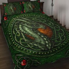 a bed covered in a green dragon comforter