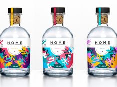 three bottles of home gin on a white surface