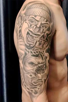 a man's arm with tattoos on it and an image of two clowns