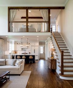 a living room filled with furniture and a stair case