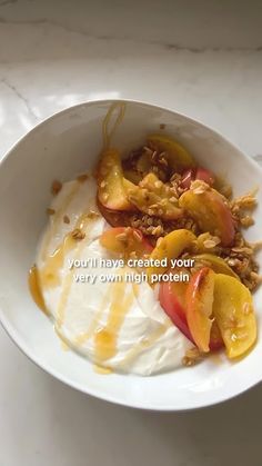 a bowl filled with yogurt and fruit on top of a white countertop