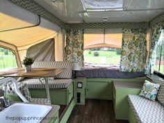 the inside of a camper with green and white decor