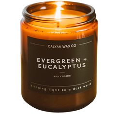 an orange candle with the words evergreen eucalyptus and eucalyptus