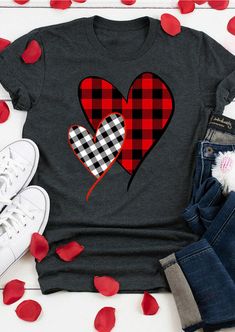 a t - shirt that has two hearts on it and is surrounded by red petals