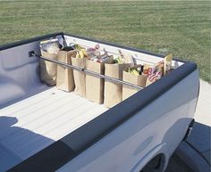 the back end of a pick up truck with bags and groceries in it's bed