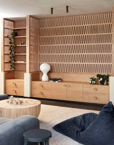 a living room filled with furniture and wooden shelves