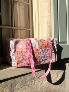 An F&R online exclusive design The Pink Patchwork Duffle Bag is a quality, structured, quilted duffle bag with an array of beautiful handprinted floral prints inside and out. Complimented with a pink stripe strap. This handmade duffle is perfect for weekends away in style. Approximately 18" x 12" x 10" Care Instructions: Machine wash on cold and hang to dry. Due to the nature of the 100% hand printed fabric there may be minor flaws and returns will not be accepted. Handmade by artists in India - Quilt Duffle Bag, Diy Duffle Bag, Quilted Duffle Bag, Duffle Bag Patterns, Pink Duffle Bag, Pink Patchwork, Pink Patch, Hand Printed Fabric, Roller Rabbit