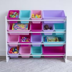 a toy storage unit with lots of bins and toys on it's sides