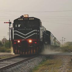 a train is coming down the tracks with its lights on