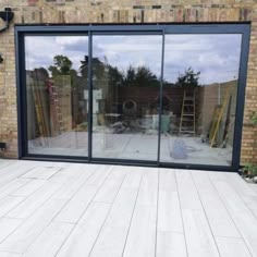 a large glass sliding door in front of a brick building