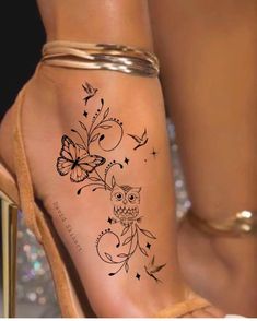 a woman's foot with an owl and butterfly tattoo on the left side of her leg