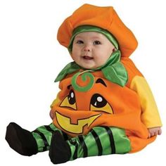 a baby in a pumpkin costume sitting on the ground with a sign that says, look no further for the look you want